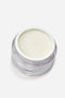 Vasetto di vetro trasparente con gel costruttore per unghie professionale "SCULPTING" color latte cremoso e autolivellante. Il gel è visibile all'interno del vasetto, mostrandone la densità e la tonalità neutra.