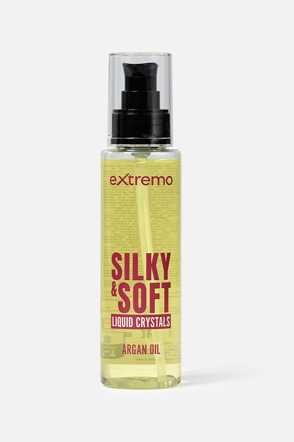 Flacone spray trasparente di cristalli liquidi per capelli "Silky & Soft" del marchio Extremo con olio di argan, contenente un fluido dorato. sfondo bianco.