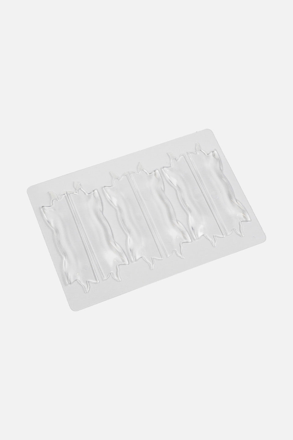 Vista dall'alto di una confezione contenente tre paia di bigodini piatti ondulati in silicone trasparente per il trattamento di laminazione ciglia coreana, disposti su un blister protettivo.