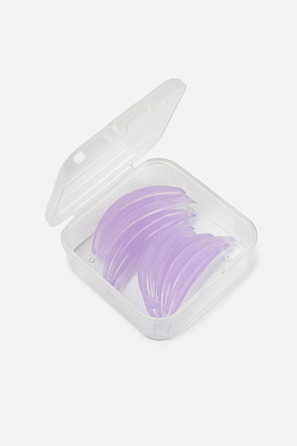 Un set completo di bigodini curvi viola in silicone per laminazione ciglia coreana, ordinati per dimensione decrescente in una scatola di plastica trasparente aperta.