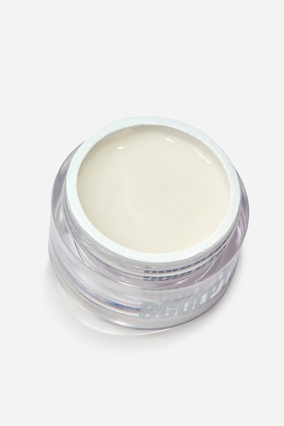 Vasetto di vetro trasparente con gel costruttore per unghie professionale "SCULPTING" color latte cremoso e autolivellante. Il gel è visibile all'interno del vasetto, mostrandone la densità e la tonalità neutra.