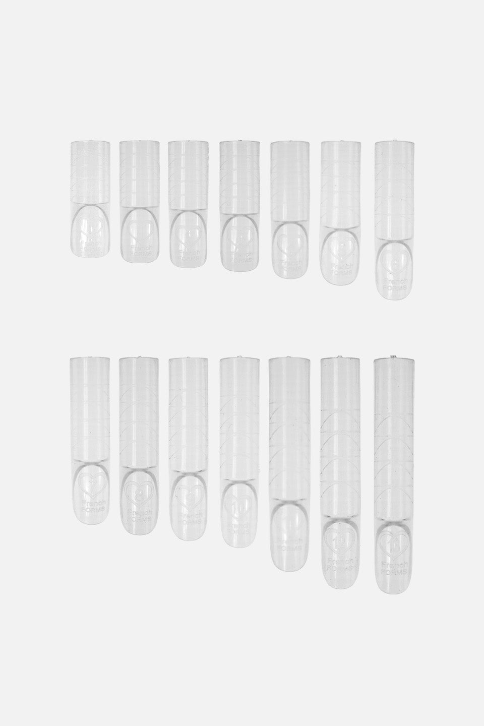Serie di Dual Form trasparenti di varie dimensioni disposte su due file; le tip presentano linee guida graduate per una lunghezza precisa e il logo "French Forms" con un cuore impresso sulla base.