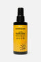 Flacone di latte solare spray su sfondo neutro. Flacone in plastica nera con etichetta gialla e scritte nere. 