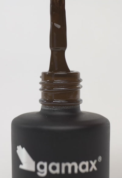 Applicazione di smalto semipermanente su un dito: il video mostra la texture e il colore del prodotto, insieme al pennello e al flacone.