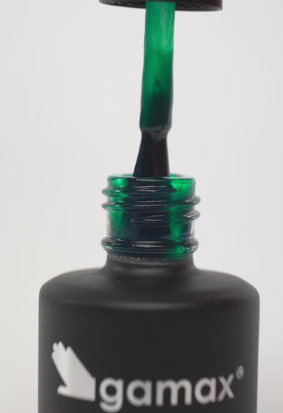 Video ravvicinato dello smalto semipermanente "Money" da 15 ml in una tonalità verde smeraldo vivace. La sequenza mostra il pennello che estrae il prodotto dal flacone evidenziandone la texture fluida, seguito dalla stesura precisa e uniforme sull'unghia del pollice per un finish lucido e coprente.